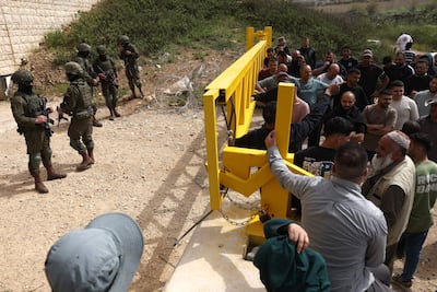Israeli security forces stop Palestinians from trying to reach their land after settlers reportedly attacked local farmers working on their land, spraying them with pepper spray, near the Palestinian village of Halhoul, south of the Israel-occupied West Bank city of Hebron, on April 17, 2026. AFP