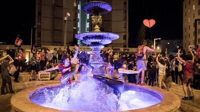 Protesters stand at the fountain of Paris Square during a protest against Israeli Prime Minister Benjamin Netanyahu outside his residence in Jerusalem, Israel. EPA