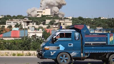 A plume of smoke rises from a building during a reported Russian air strike on Syria's northwestern rebel-held Idlib province. AFP