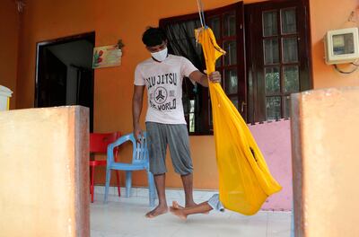 Prasad Dinesh pushes his daughter in a swing at their home in Ja-Ela, Sri Lanka. AP