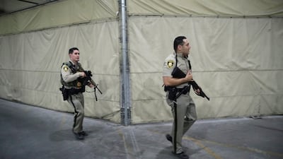 Police officers enter the Mandalay Bay resort and casino during a shooting near the Mandalay Bay resort and casino on the Las Vegas Strip. John Locher / AP Photo