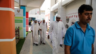 Men arrive to vote at a polling station on the Bahraini island of Muharraq.