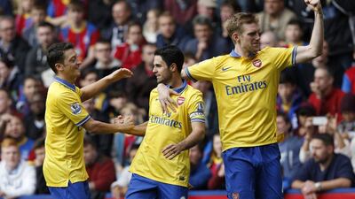 Arsenal top the Premier League table with 22 points from nine matches. Sang Tan / AP