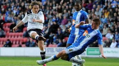 Wigan's James McCarthy, right, blocks a shot from Tottenham's Luka Modric during their stalemate at the DW Stadium yesterday.