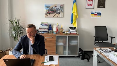 The Ukrainian flag and a message on solidarity forms the backdrop in the office of Leszek Bonna, marshal of Poland’s northern Pomerania region. Ramola Talwar Badam/ The National
