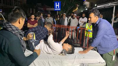 Afghan health workers carry a wounded child into the hospital after a suicide attacker exploded his explosive vest among a wedding ceremony in a wedding hall in Kabul. EPA