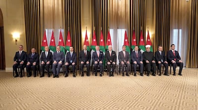 Jordan's King Abdullah II and Prime Minister Omar Razzaz, centre, pose with members of the new cabinet after a reshuffle on November 7, 2019. Jordanian Royal Palace / AFP