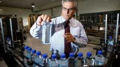 Fasahat Beg, general manager of Al Ain Mineral Water, examines a bottle on his company's production line.