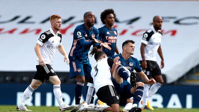 Arsenal's Granit Xhaka is tackled by Michael Hector of Fulham. PA