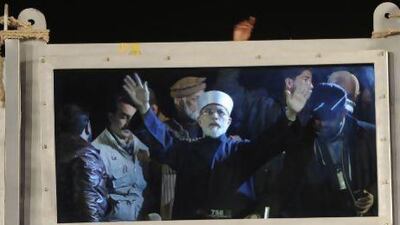 The cleric Tahir-ul-Qadri talks to supporters during a protest in Islamabad on Tuesday. T Mughal / EPA
