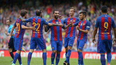 Barcelona midfielder Arda Turan (C) celebrates with teammates after scoring the opening goal of the pre-season International Champions Cup football match between Spanish champions, Barcelona and Scottish Premiership champions, Celtic at the Aviva Stadium in Dublin on July 30, 2016. Paul Faith / AFP