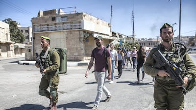 Israeli soldiers escort Ido Even-Paz and his Breaking the Silence tour through the West Bank city of Hebron on September 27,2018. Heidi Levine for The National