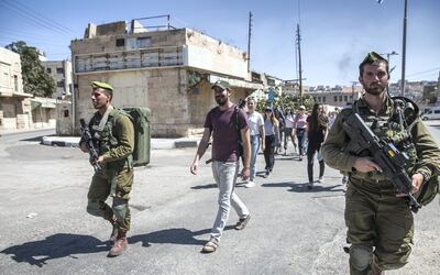 Israeli soldiers escort Ido Even-Paz and his Breaking the Silence tour through the West Bank city of Hebron on September 27,2018. Heidi Levine for The National