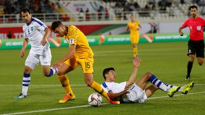Chris Ikonomidis, centre, of Australia in action. EPA