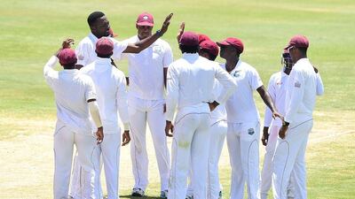 West Indies bowler Sulieman Benn is congratulated by Kemar Roach after Anamul Haque of Bangladesh was caught out by Denesh Ramdin off Benn's delivery on Day 4 of the second and final Test against Bangladesh on Tuesday. Frederic J Brown / AFP / September 16, 2014