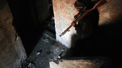 A rebel fighter carries his rifle down the stairs of a building in the northern Syrian city of Aleppo on February 9, 2014. The civil war in Syria has claimed more than 136,000 lives and driven millions from their homes, many of whom have fled to neighbouring Turkey, Lebanon, Jordan and Iraq, raising fears of a regional spillover of the conflict. Mohamed Abdel Rahman / AFP photo