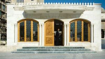 Dr Mahmoud al Masri at the entrance to the Waqf Library of Aleppo in Syria. He has been in charge of the library restoration project since 2006.