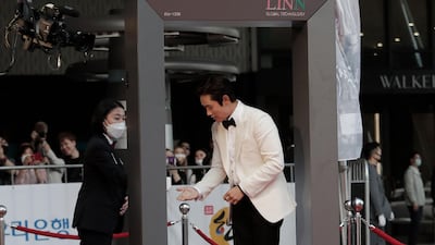 Lee Byung-hun receives hand sanitiser. AP