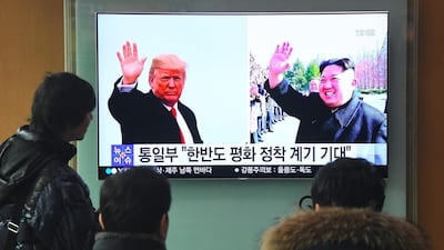 People watch a television report on a planned meeting between US President Donald Trump and North Korean leader Kim Jong-un, at a railway station in Seoul on March 9, 2018. Jung Yeon-je / AFP