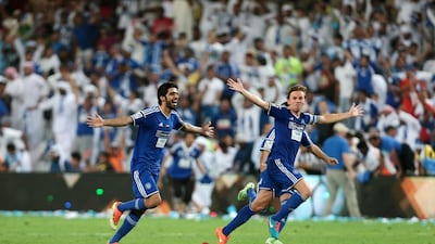 Al Nasr's Brett Holman, right, and Hassan Mohamed celebrate defeating Al Ahli during the President's Cup final match at Hazza bin Zayed Stadium in Al Ain on June 3, 2015. Christopher Pike / The National