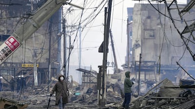 People walk through the damaged marketplace in Wajima, Ishikawa prefecture. AP