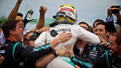 Lewis Hamilton celebrates with his Mercedes team after winning the Formula One Canadian Grand Prix in Montreal on Sunday. Andre Pichette / EPA / June 12, 2016