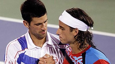 Novak Djokovic, left, consoles Feliciano Lopez after the Serb's hard-fought victory in Dubai.