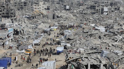 Palestinians walk through the rubble of buildings destroyed during the Israeli offensive, in Jabalia refugee camp, northern Gaza. Reuters