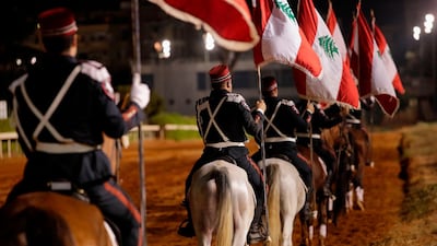 Members of the Lebanese Cavalry Division parade with national flags during the Glory Horse Racing Festival at the Beirut Hippodrome. AFP
