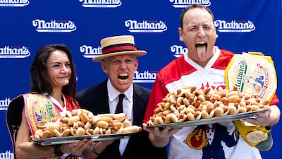 Competitive eaters Michelle Lesco and Mr Chestnut pose before the event. AP