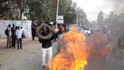 Supporters of Kenyan opposition leader and presidential candidate Raila Odinga block roads with burning tyres in the Kibera slum in Nairobi, Kenya, Friday August 11, 2017. Mr Odinga says hackers infiltrated the database of the country's election commission and manipulated the results . Early results show President Uhuru Kenyatta with a wide lead over Odinga. Khalil Senosi / AP