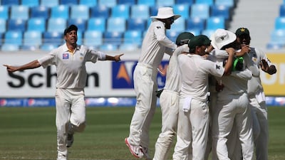 Pakistan players celebrate during Day 5 of their first Test victory against Australia in Dubai. Kamran Jebreili / AP / October 26, 2014