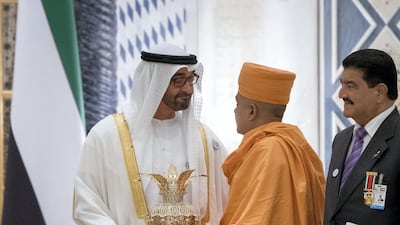 HH Sheikh Mohamed bin Zayed Al Nahyan Crown Prince of Abu Dhabi Deputy Supreme Commander of the UAE Armed Forces (L) is presented with a gift, during a reception held at the Presidential Palace. Seen with Dr B R Shetty, CEO and Managing Director of the New Medical Centre (R). Photo: Rashed Al Mansoori / Crown Prince Court - Abu Dhabi