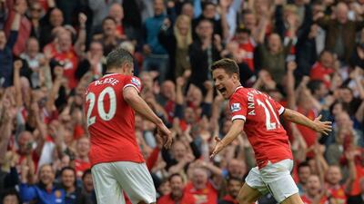 Manchester United's Ander Herrera, right, celebrates scoring their second goal with striker Robin van Persie, left, during their EPL victory over QPR on Sunday. Pal Ellis / AFP