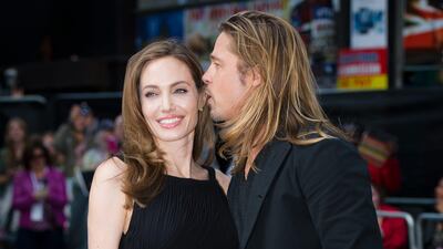 Angelina Jolie, left, was called "heroic" by her partner Brad Pitt for undergoing the surgery. Leon Neal / AFP