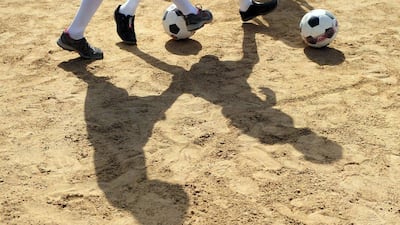 The shadows of youth are shown in Karachi, Pakistan training at a local pitch as part of an academy funded by the Real Madrid Foundation. Asif Hassan / AFP
