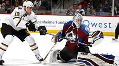 The Colorado Avalanche goalie Craig Anderson, right, makes a save against Dallas.