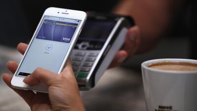 A customer makes a transaction using Apple Pay at The Dubai Mall. Francois Nel / Getty Images.