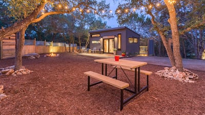 8. See the stars from this tiny home in Texas which has a hot tub perfect for two, a private yard, charcoal grill, picnic table, double hammock and twinkle lights hanging from the trees.
