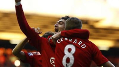 Liverpool's Albert Riera holds his arm aloft as he celebrates scoring the opener with Steven Gerrard.