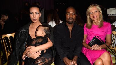 From left, Kim Kardashian holding baby North West, Kanye West and Helene Arnault at the Givenchy show at Paris Fashion Week. Pascal Le Segretain / Getty Images