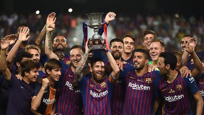 Barcelona's Lionel Messi lifts the Super Cup. Reuters