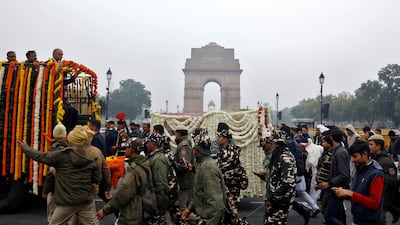 The funeral procession passes India Gate war memorial in New Delhi. Reuters