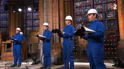 The Maitrise Notre-Dame de Paris choir stood socially distanced and in hard hats and protective suits while performing inside the cathedral. AFP
