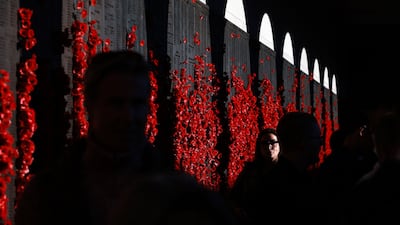 People pass the remembrance wall before the Last Post ceremony at the Australian War Memorial in Canberra. AFP