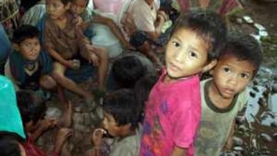 Karen villagers, mostly women and children, take refuge from the fighting inside the Thai border.