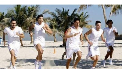 From left, AC Milan's Gianluca Zambrotta, Zlatan Ibrahimovic and Bruno Montelongo train at the Al Mamzar Beach Park in Dubai.