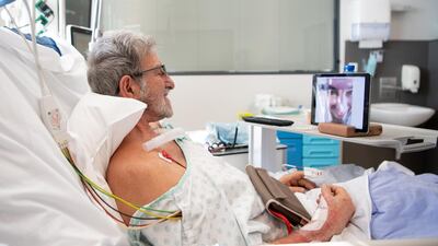 A patient with Covid-19 talks with a family member. Getty Images