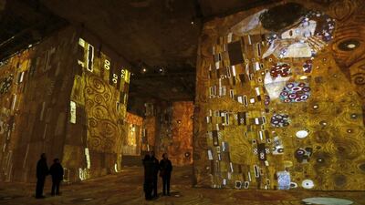 Visitors look at a sound and light show as part of the exhibition.