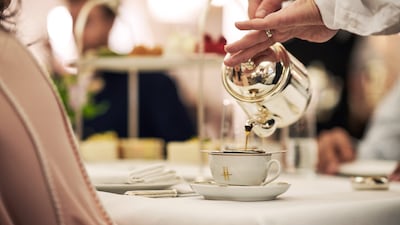 Pinky extended ... the Harrods Tea Rooms. Julian Broad